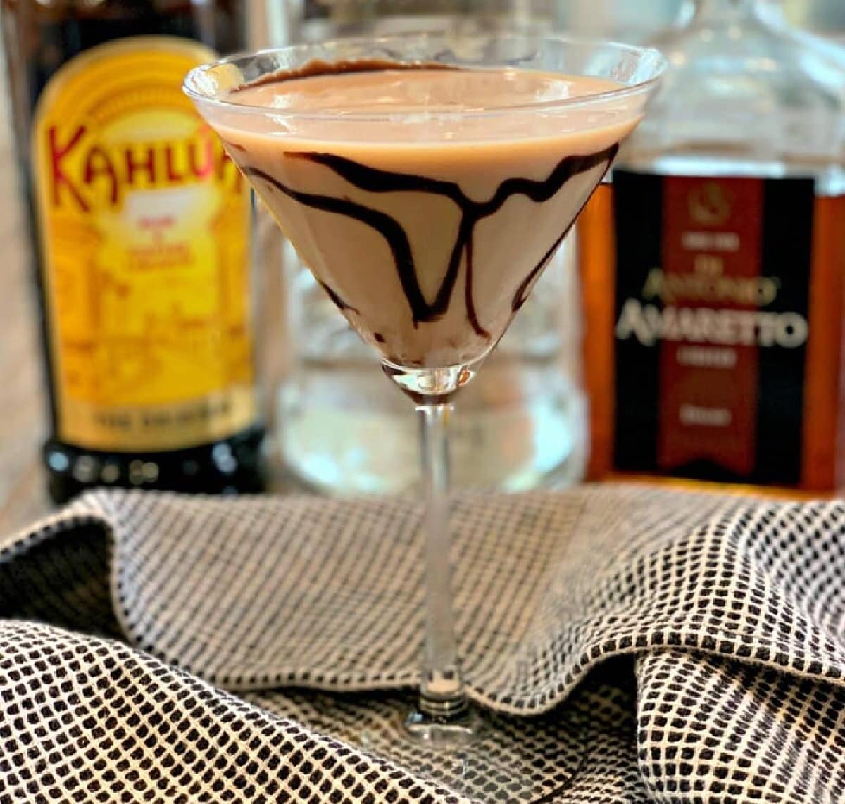 chocolate syrup swirled in a martini glass with a tiramisu mixture.
