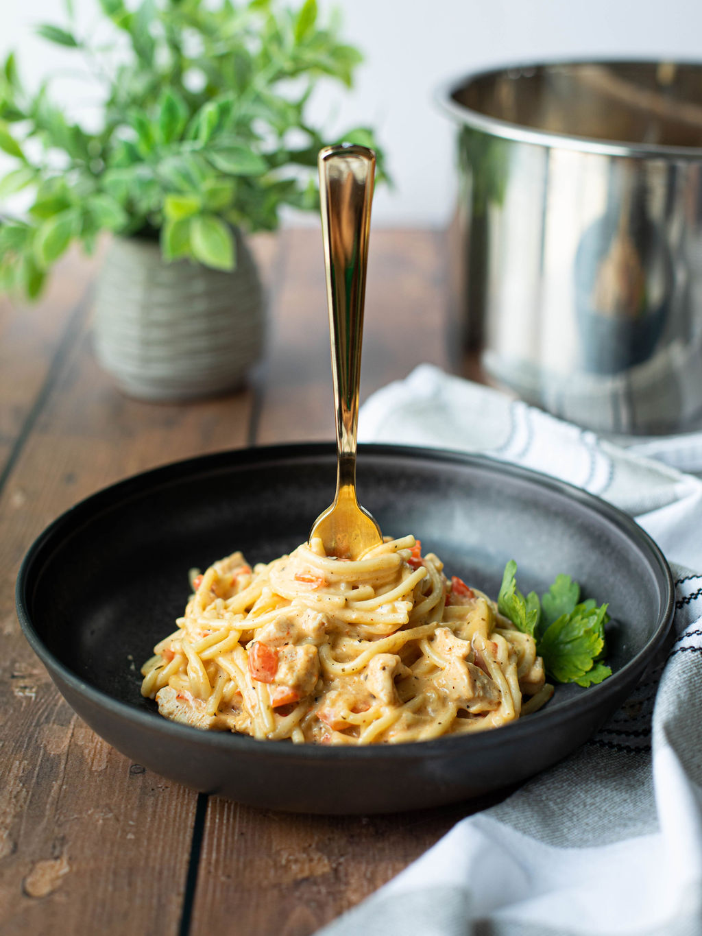 chicken spaghetti served in a black bowl after being made in the instant pot.