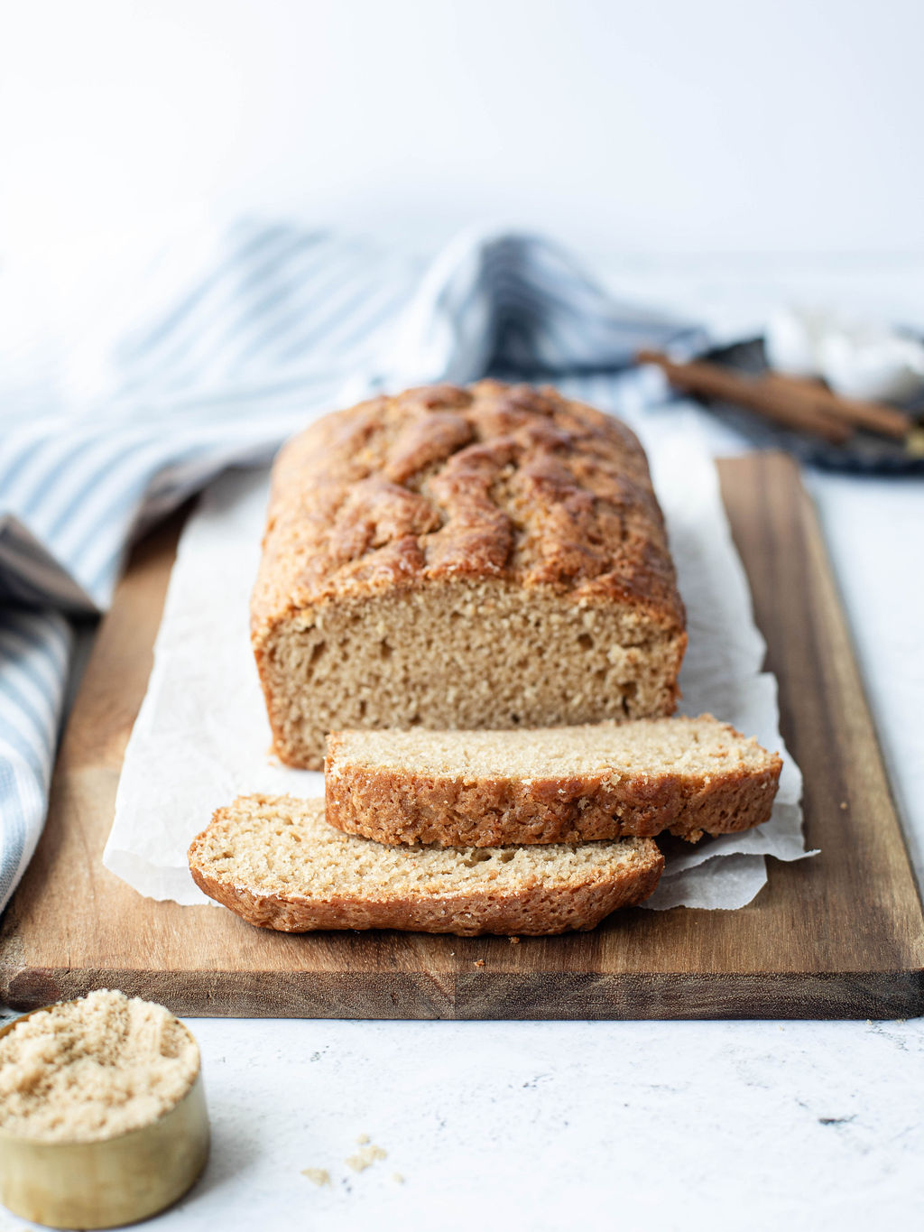 a loaf of brown sugar quick bread on a cutting board.