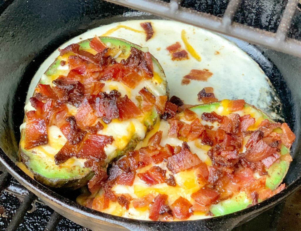 ripe avocado with scrambled egg, cheese, and bacon