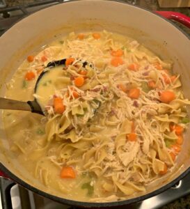creamy chicken noodle soup with carrots, celery, bacon, and shredded chicken