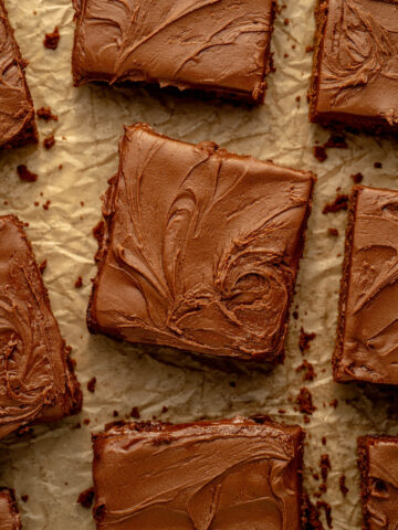 a few slices of lunch lady brownies on a piece of parchment paper.