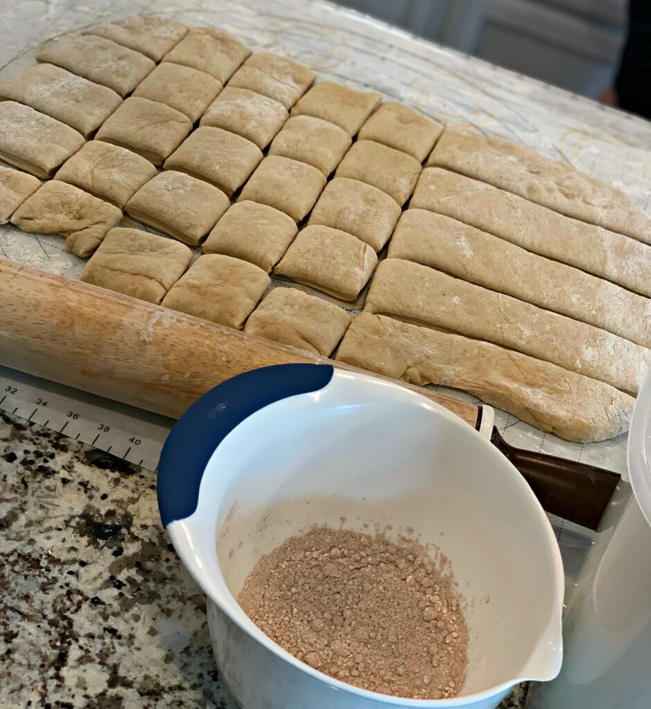 apple dough rolled out and cut into pieces, ready to be fried
