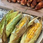 husks of tender sweet corn cooked on the smoker