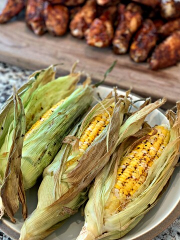 husks of tender sweet corn cooked on the smoker