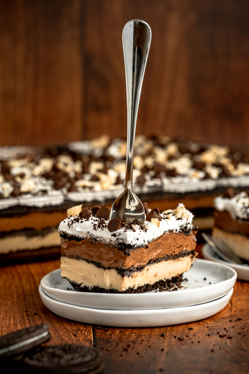 a piece of no bake chocoloate peanut butter oreo dessert