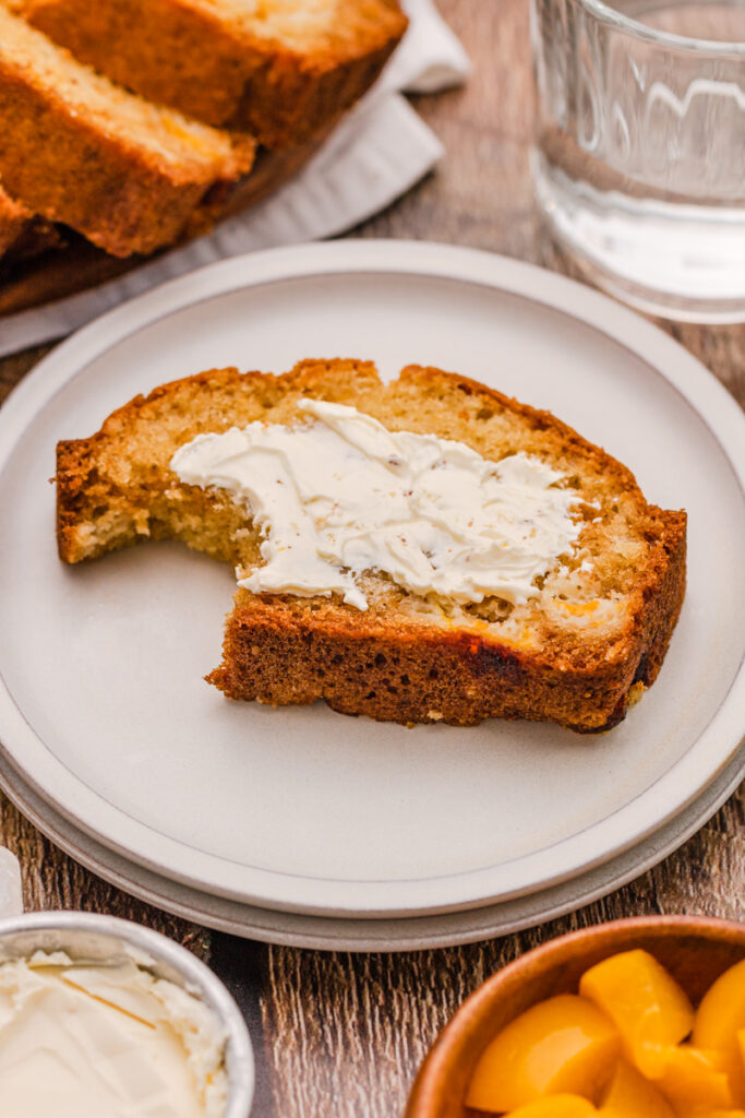 a slice of quick bread on a plate with butter