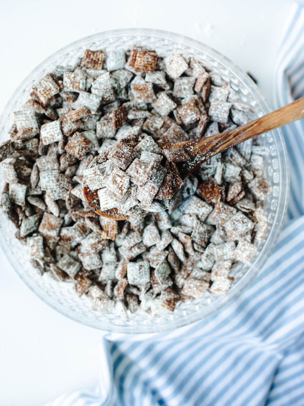 chocolate peanut butter coated Chex cereal in a glass bowl.