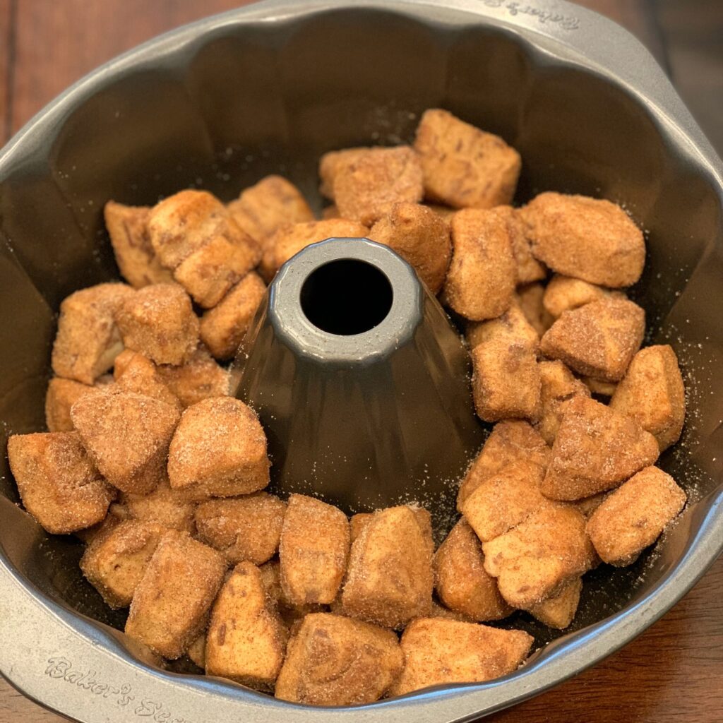 Cut up cinnamon rolls placed into bundt pan for this monkey bread