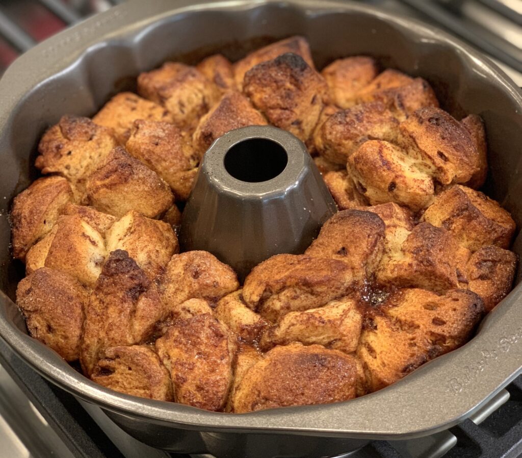 Nearly finished cinnamon roll chunks in this bundt pan for cinnamon roll monkey bread