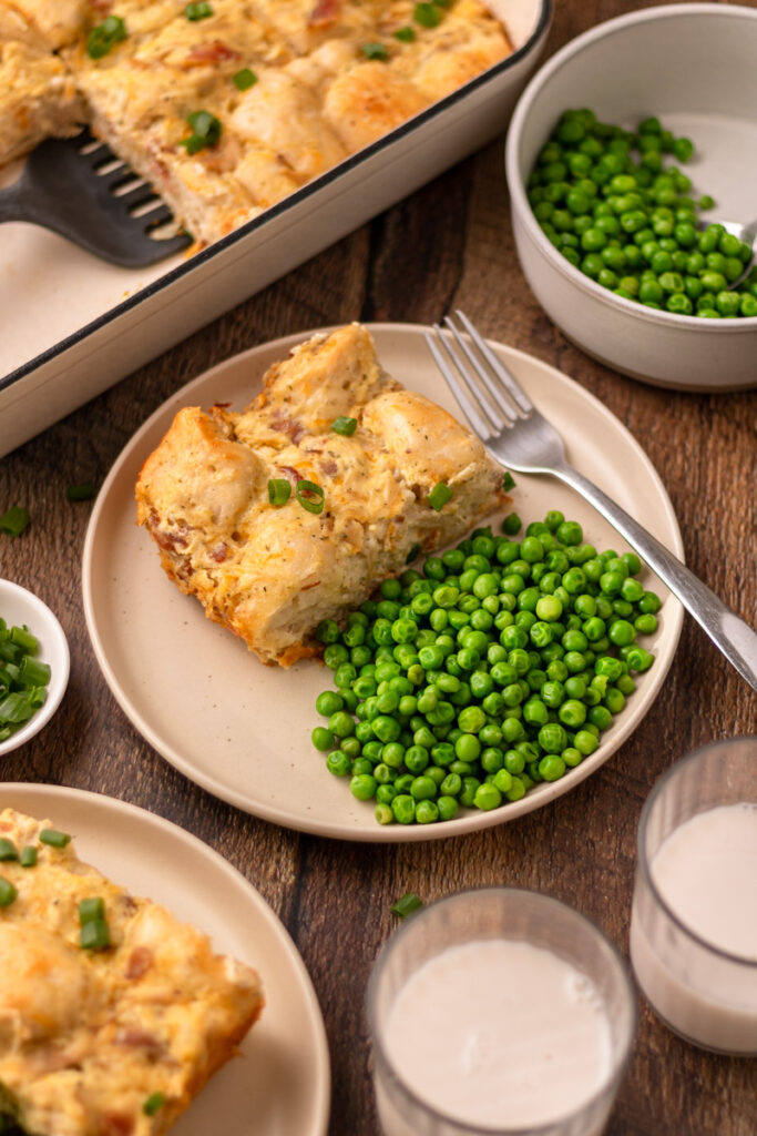 loaded crack chicken casserole served on a plate with peas.