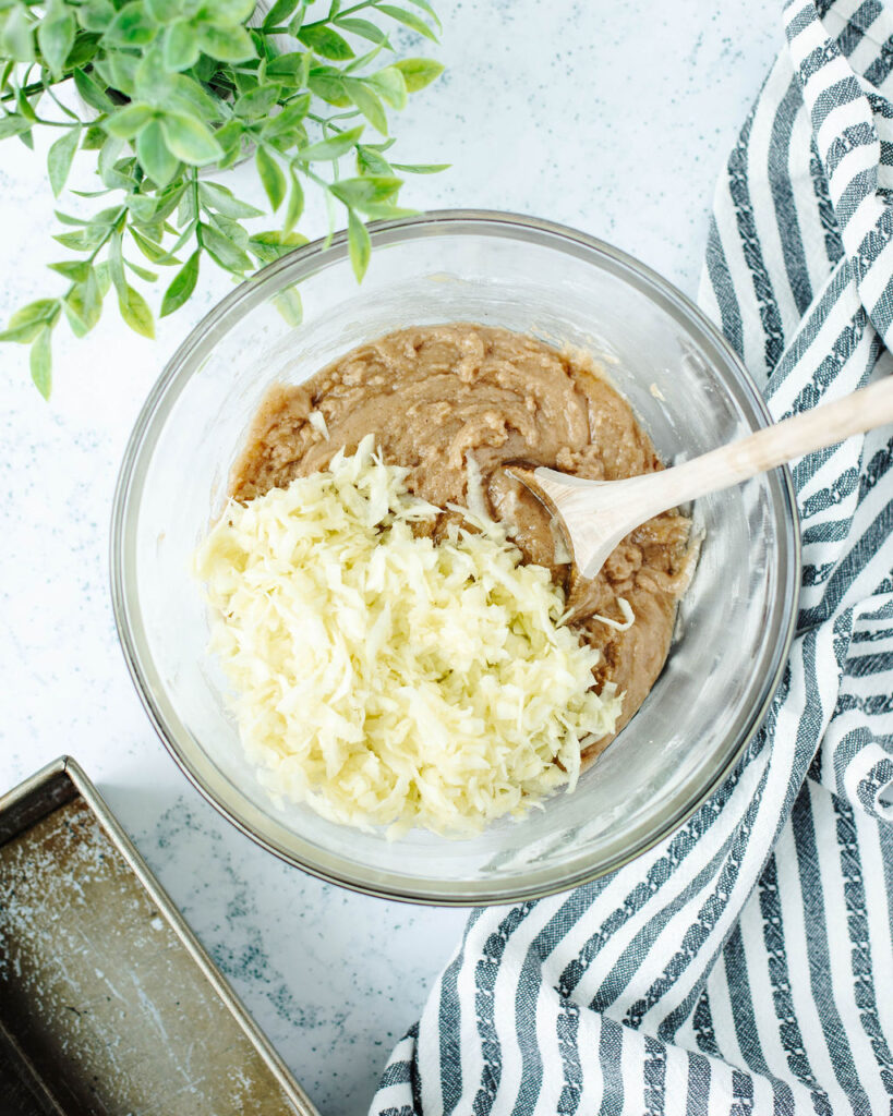 freshly grated zucchini combined in a mixing bowl with quick bread batter.