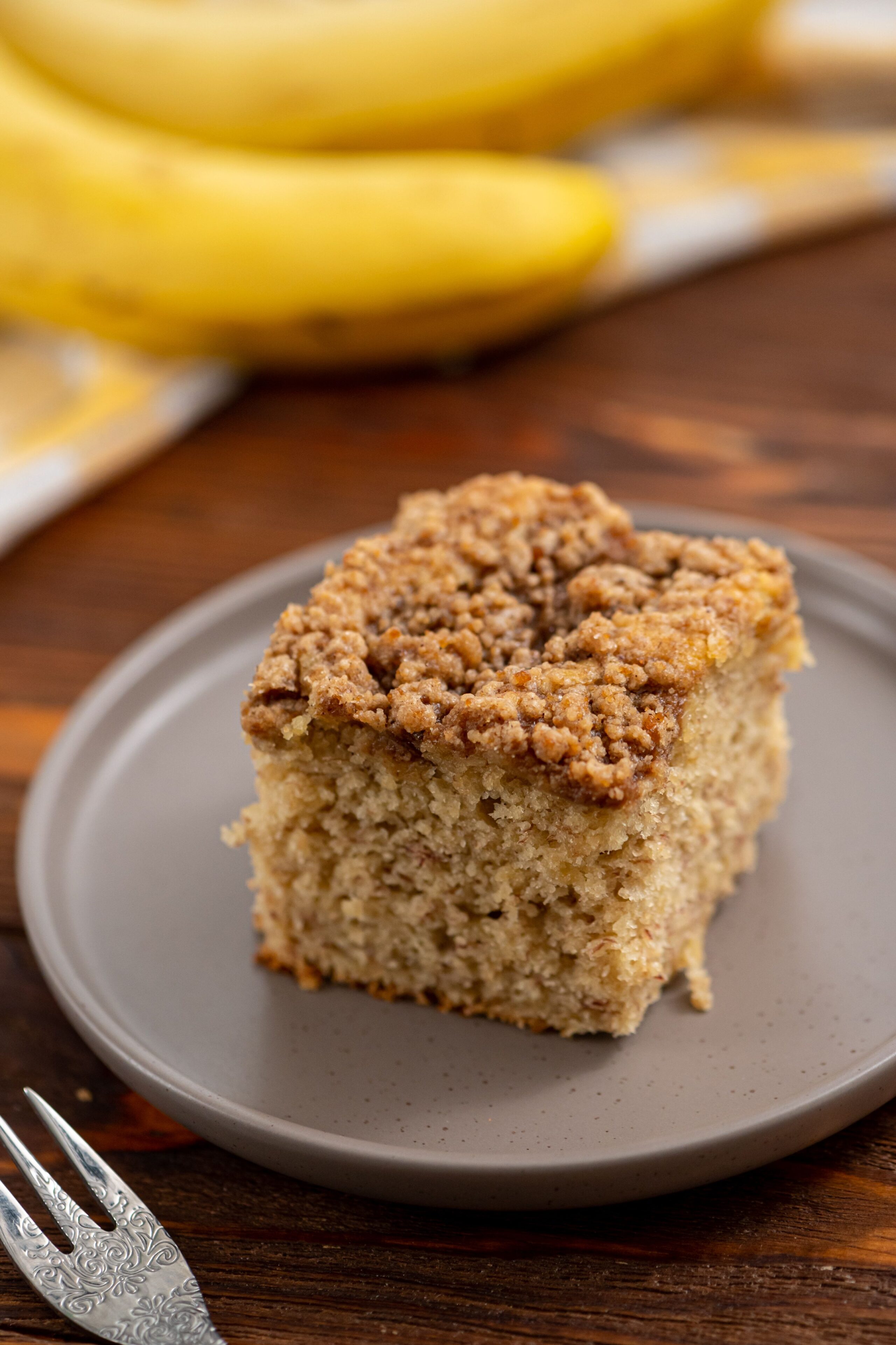 a piece of banana coffee cake on a serving plate.