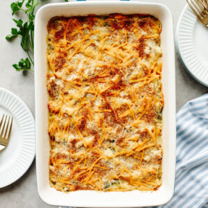 a baked rice a roni chicken casserole in a white pan.