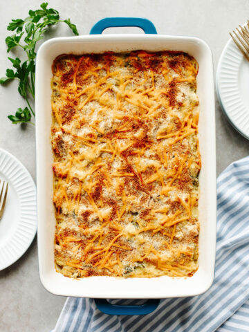 a baked rice a roni chicken casserole in a white pan.