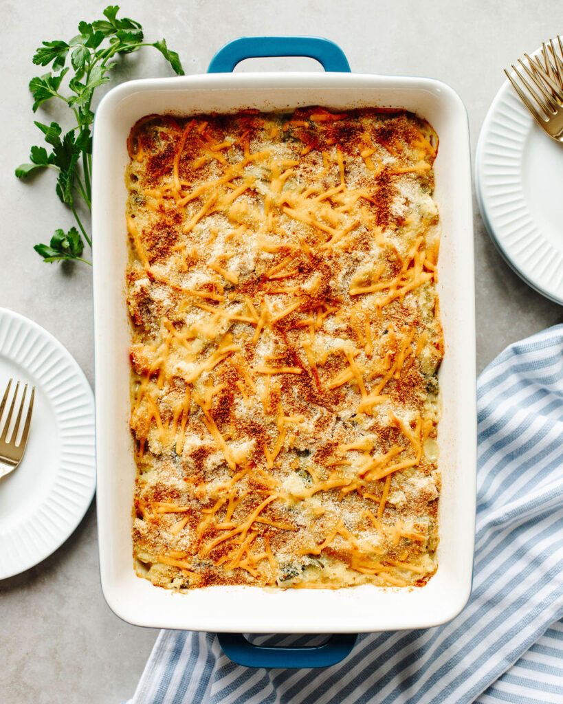 a baked rice a roni chicken casserole in a white pan.