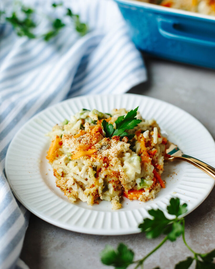 a white plate with a serving of hearty chicken bake ready to eat.