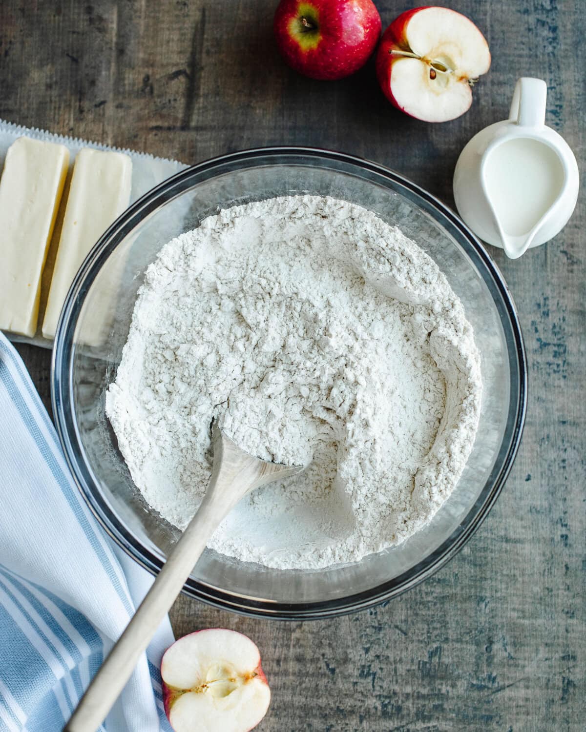 dry ingredients added to a glass mixing bowl to make biscuit dough.