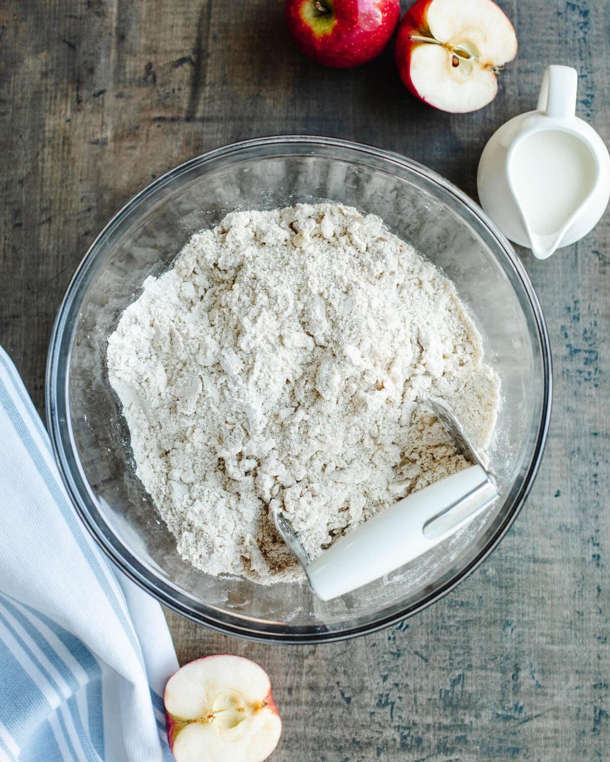 cold butter being mixed into dry ingredients using a pastry blender.