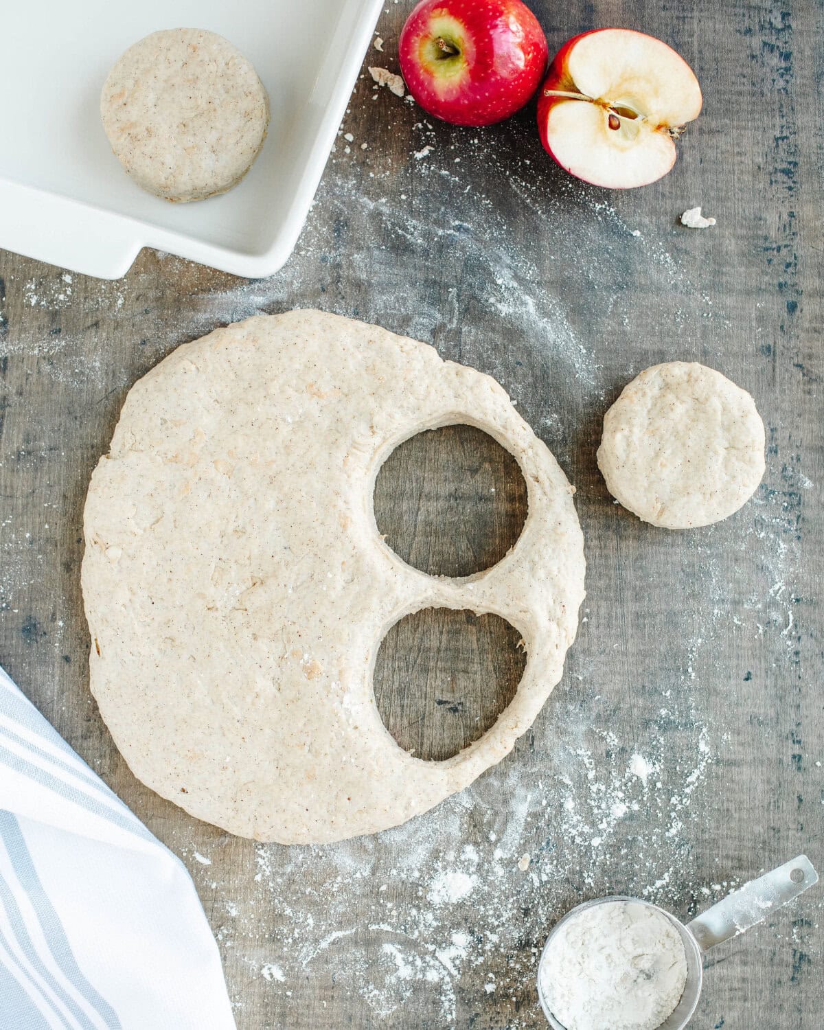 cutting out biscuits from dough on a floured cutting board.