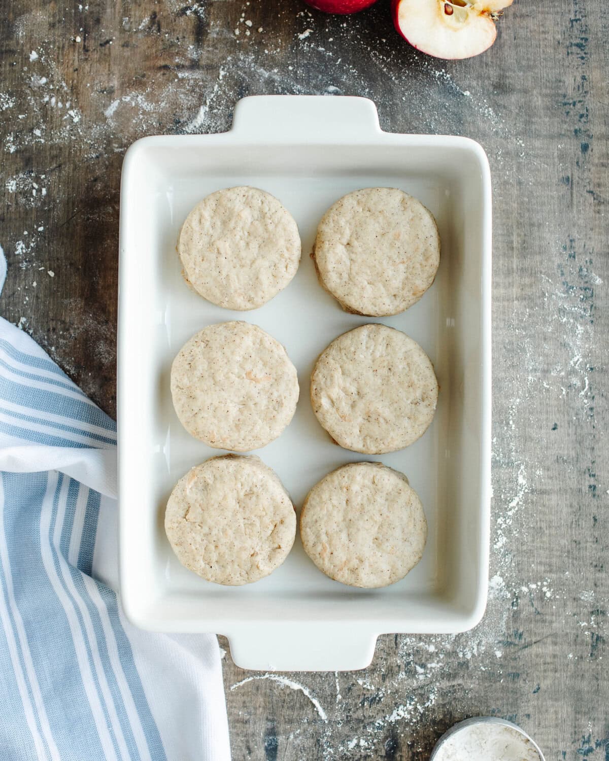 cut biscuits in a baking dish ready to bake.