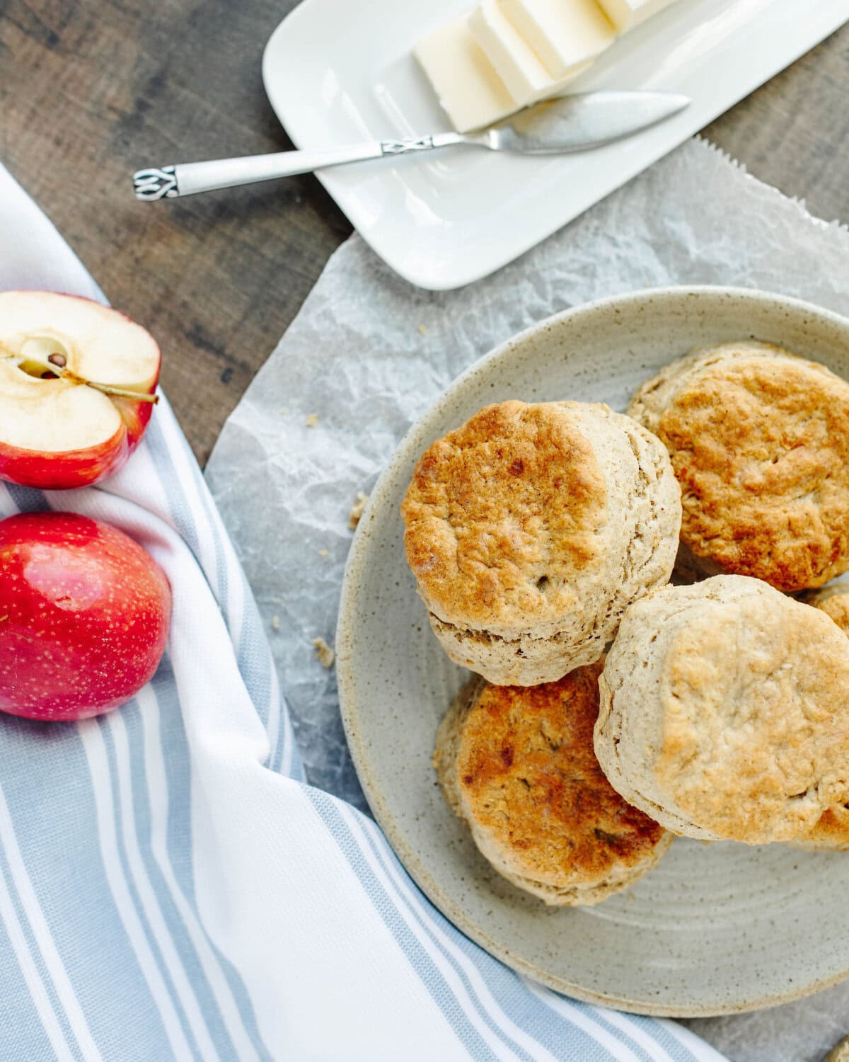 homemade apple biscuits on a plate with butter.