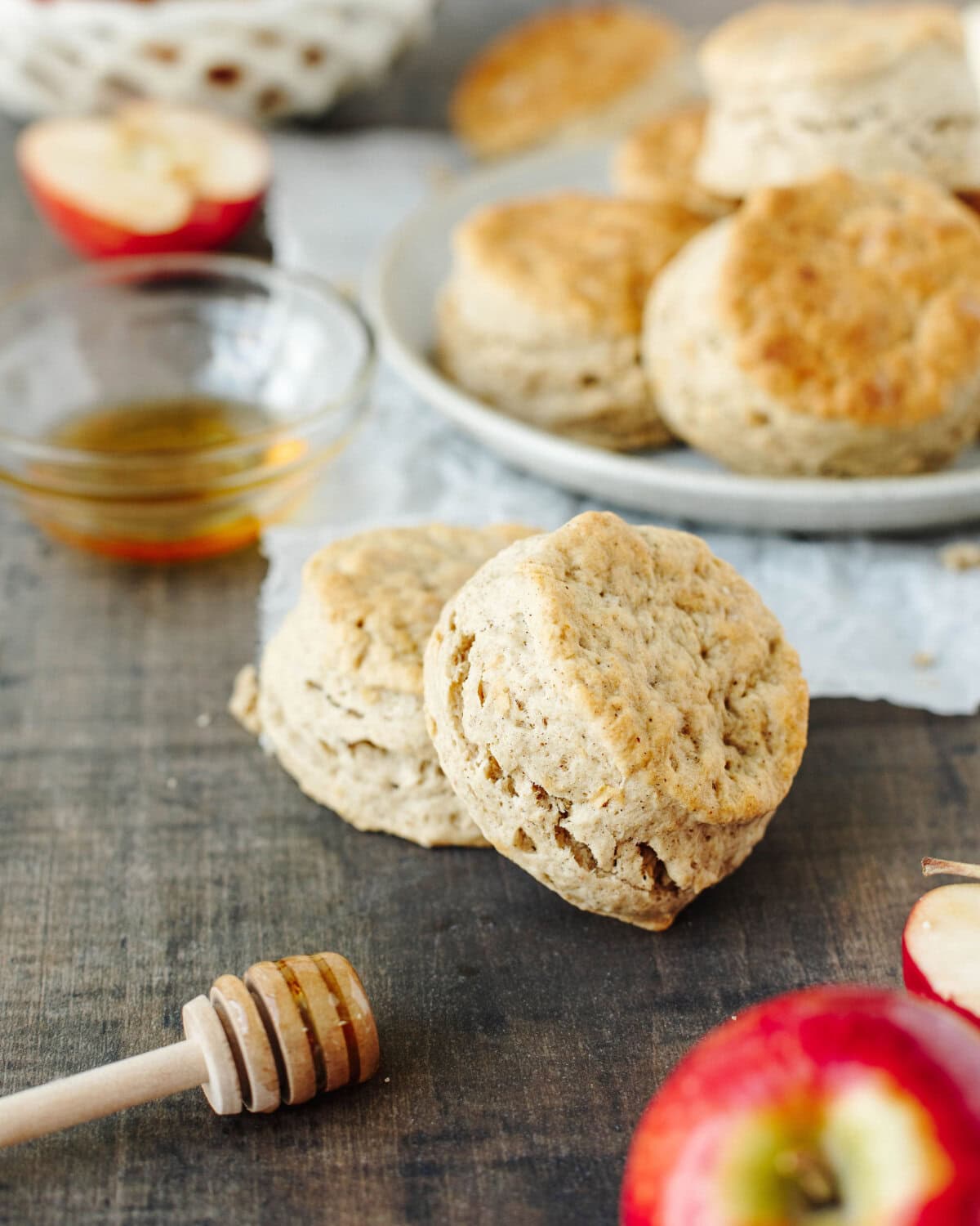 stacked apple biscuits with honey on a plate.