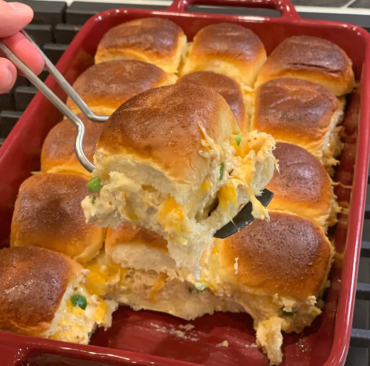 jalapeno chicken sliders in a red baking pan.