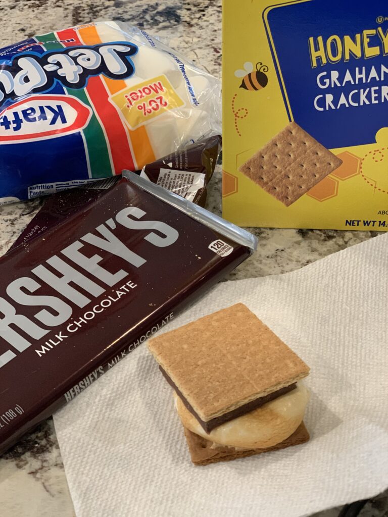 graham crackers, marshmallows, and chocolate combined into a s'more using your air fryer