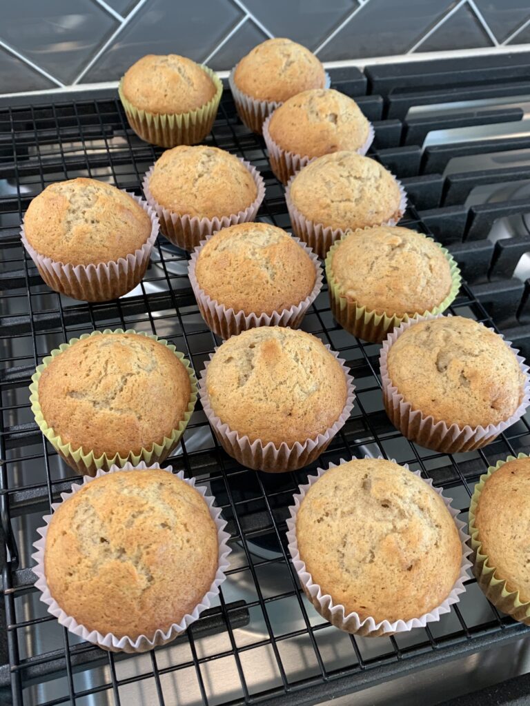 banana muffins lined up on a cooling rack