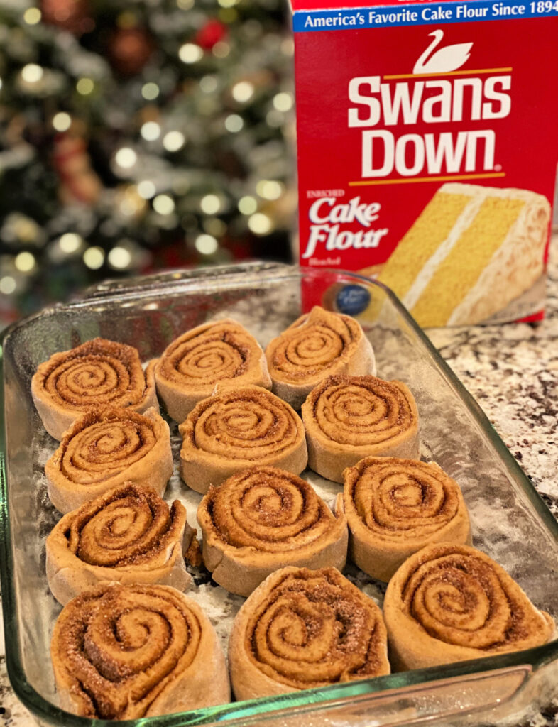 homemade cinnamon rolls lined in a baking pan 