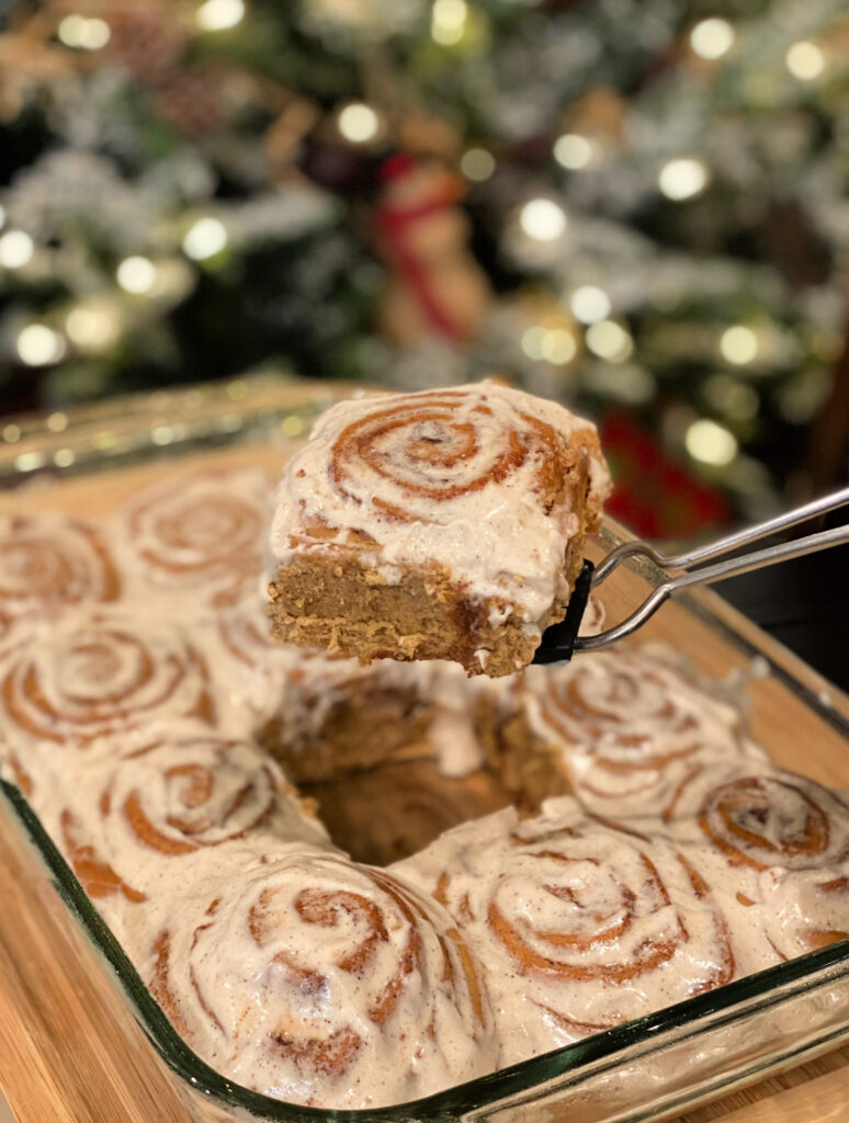 a gingerbread cinnamon roll baked and iced with a gingerbread frosting