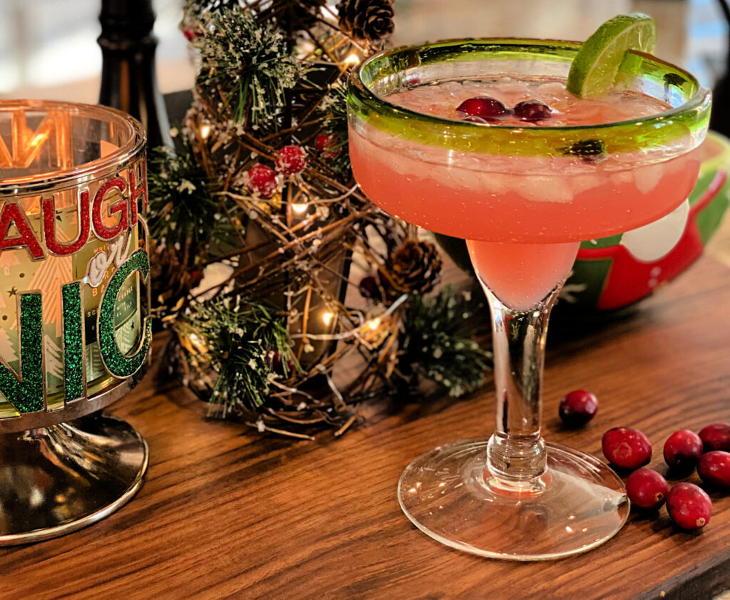 a festive margarita with pink coloring and cranberry flavors