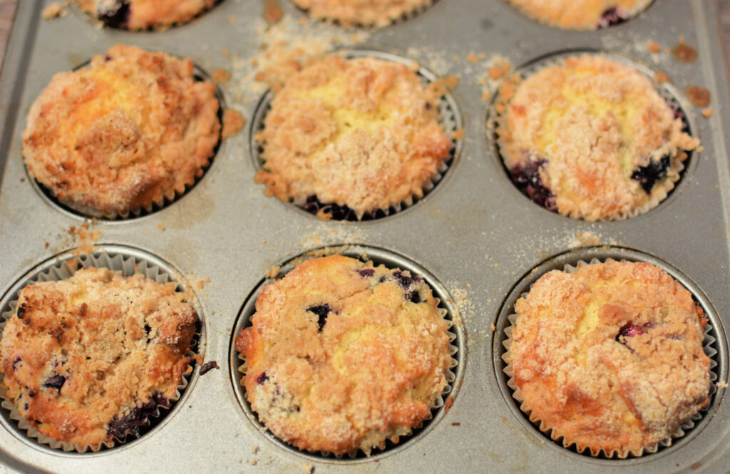 moist and fluffy bakery style muffins with a cinnamon buttery topping.