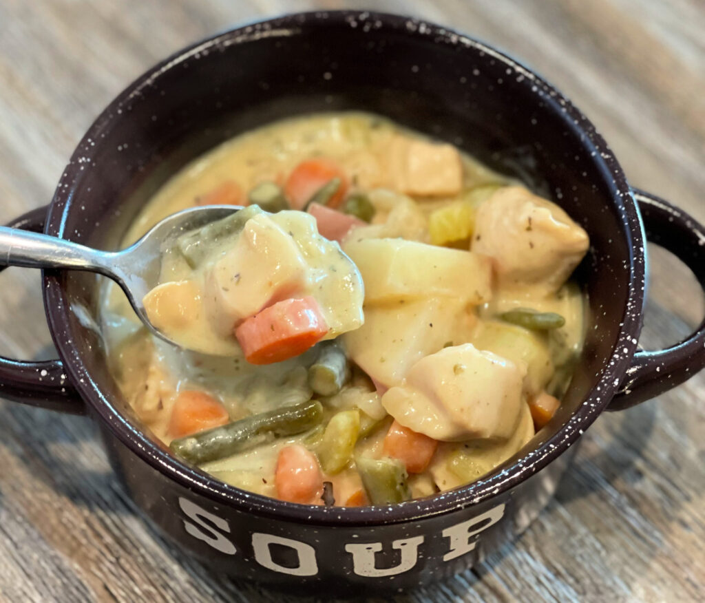 chicken stew made with carrots, potatoes, veggies, and more in a hearty broth