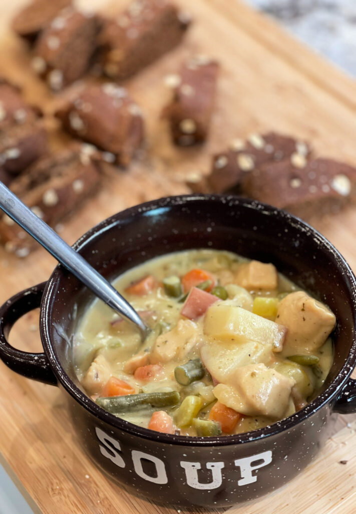 tender potatoes, chicken bits, carrots, and more combined into a hearty chicken stew