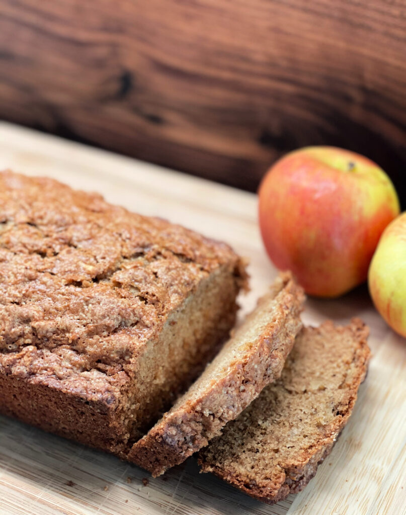 apple bread sliced and served with apples on the side