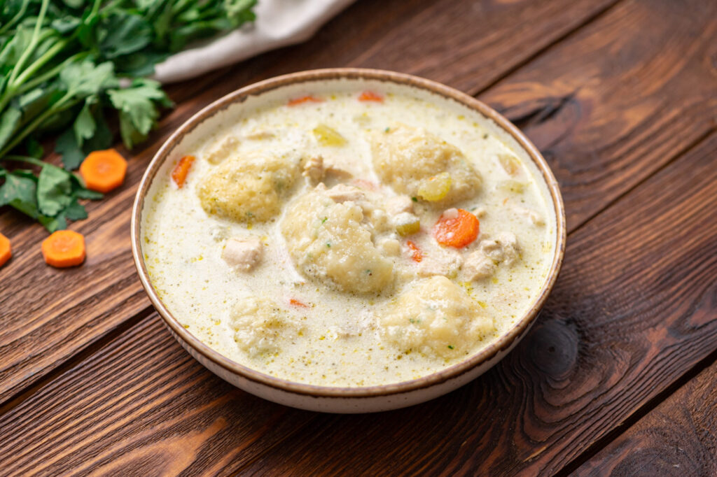 chicken, veggies, and dumplings cooked in a Dutch Oven