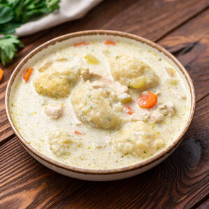 chicken, veggies, and dumplings cooked in a Dutch Oven