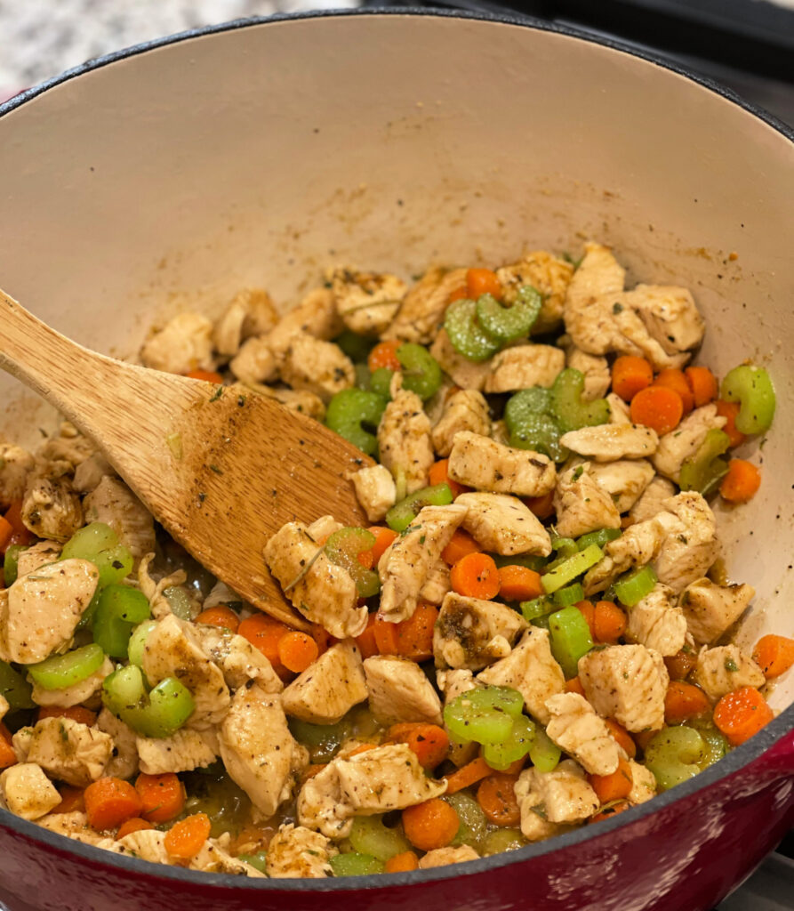 carrots, celery, and chicken combine into homemade chicken and dumplings