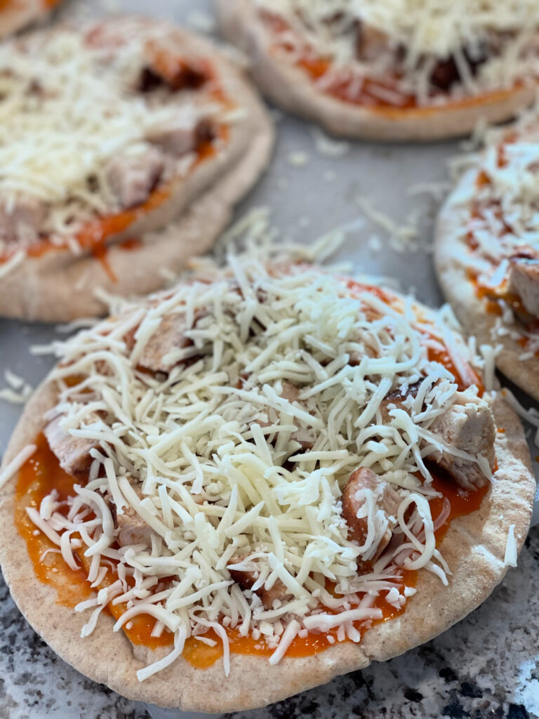 buffalo sauce, cheese, and shredded chicken cooked on a flatbread