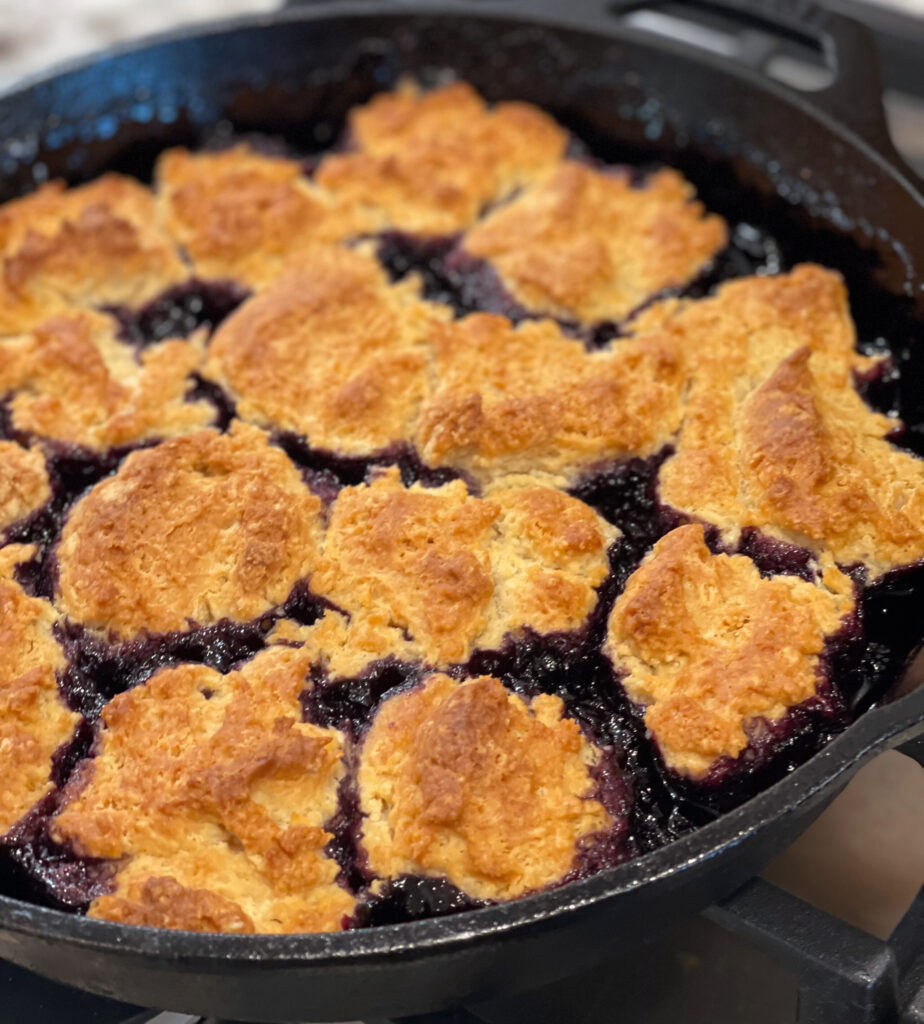 blueberry cobbler cooked in a cast iron skillet