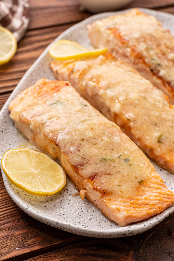 grilled salmon with a creamy lemon garlic sauce drizzled on top