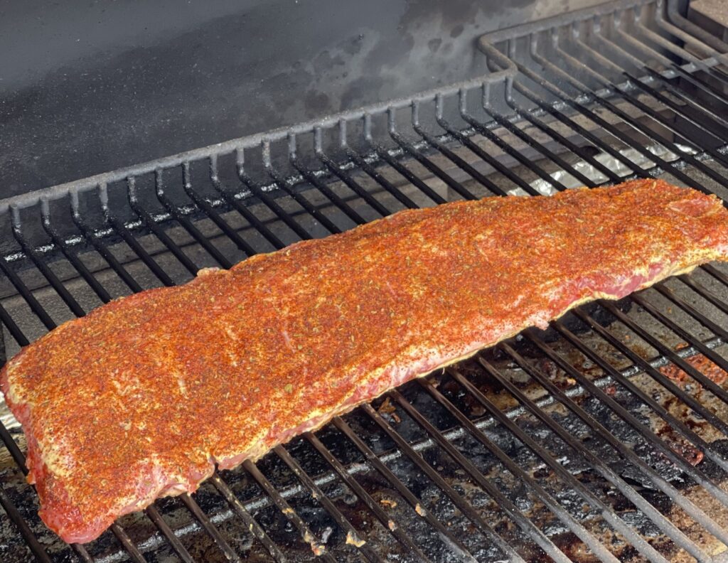 bbq seasoned baby back ribs that are cooked on the smoker