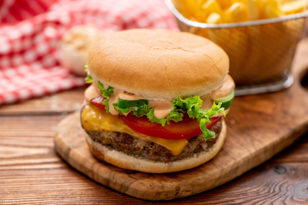 the best juicy burgers topped with seasonings, cheese, and lettuce.