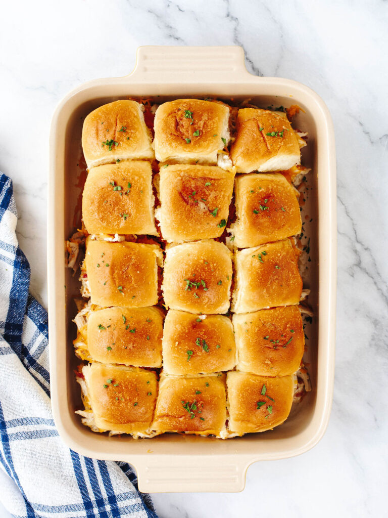 a casserole dish filled with chicken sliders ready to serve.