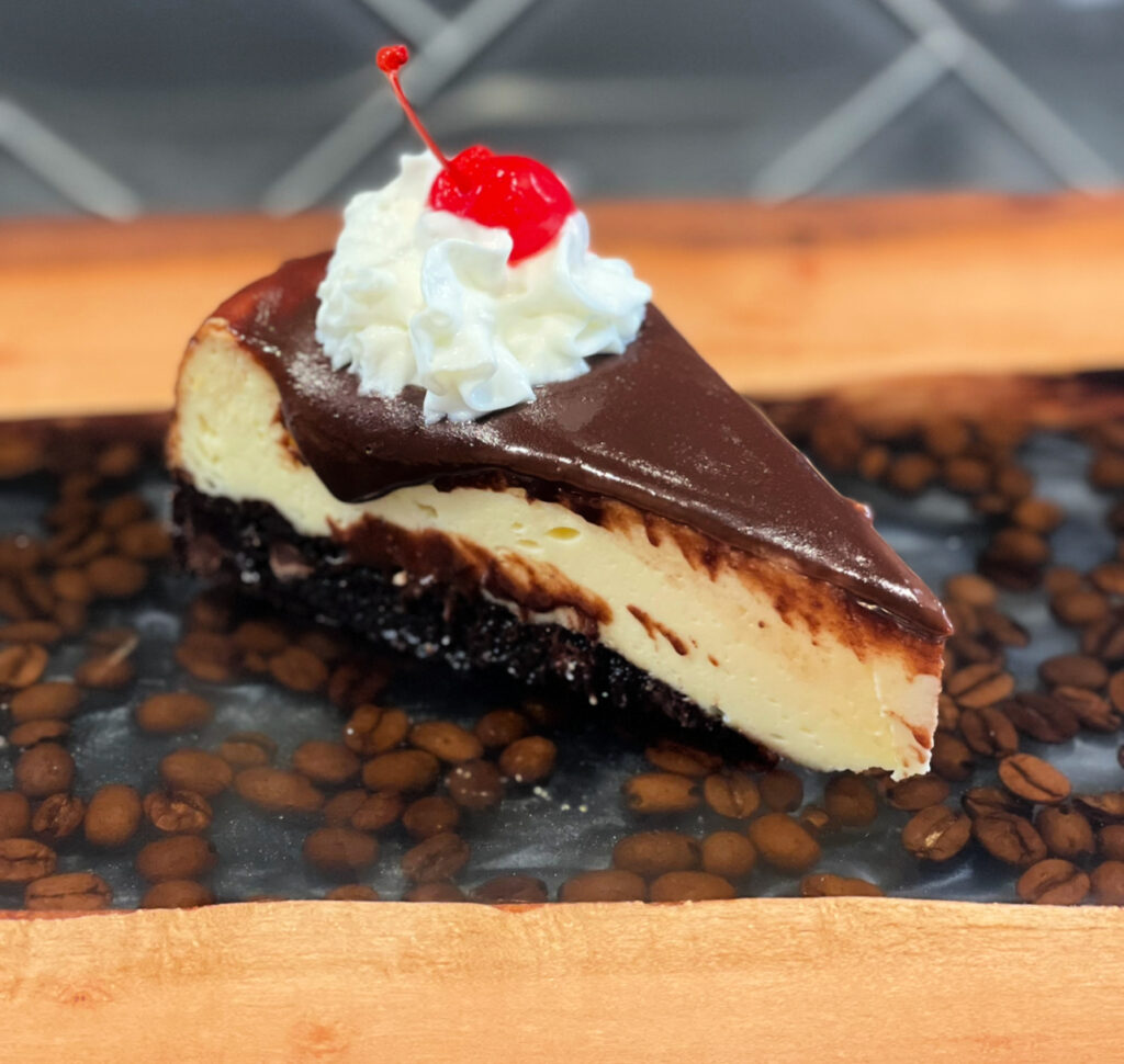 layered brownie with cheesecake and chocolate on top
