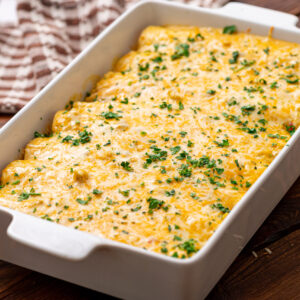 creamy chicken and cheese filled tortillas baked with a white sauce