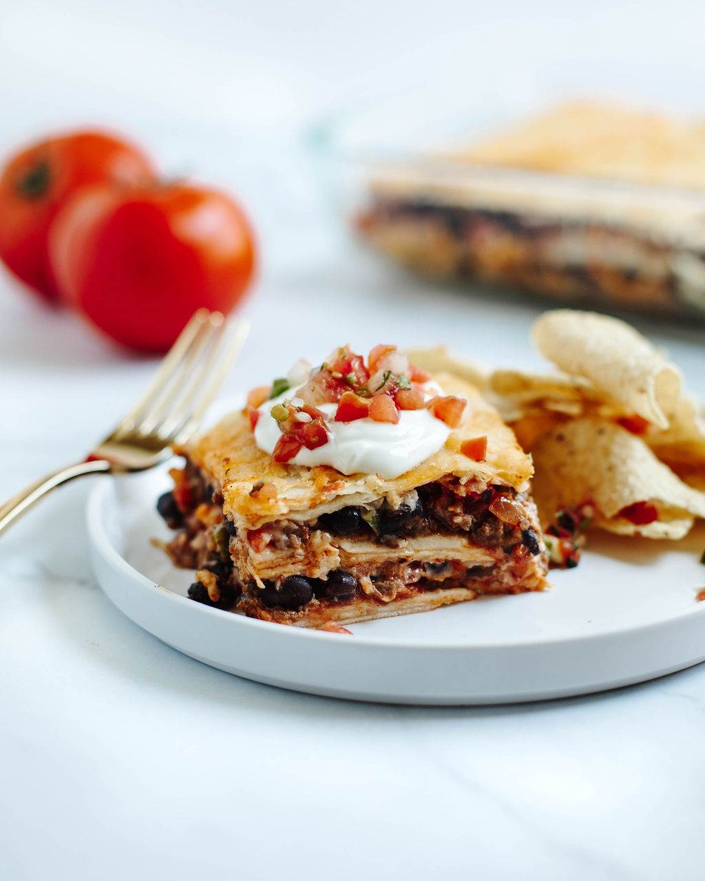 taco lasagna served on a white dinner plate.