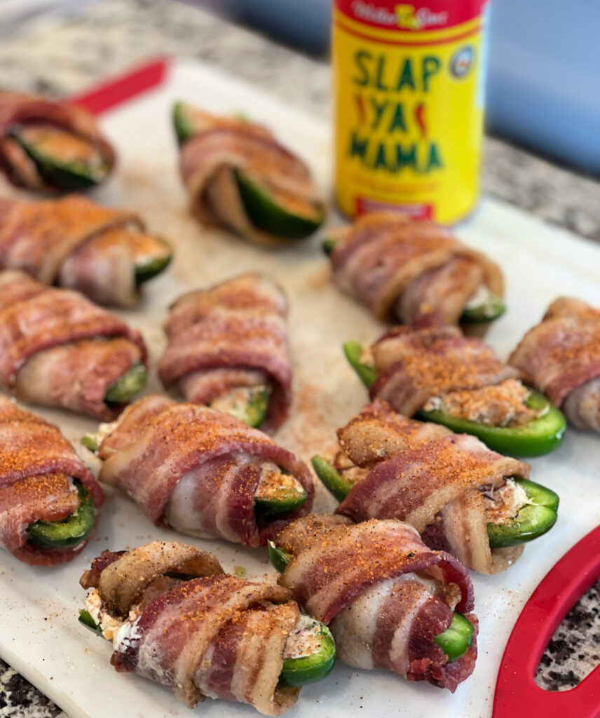 cream cheese and brisket stuffed jalapenos wrapped with bacon and sprinkled with slap ya mama seasoning. Then, cooked on the smoker or grill